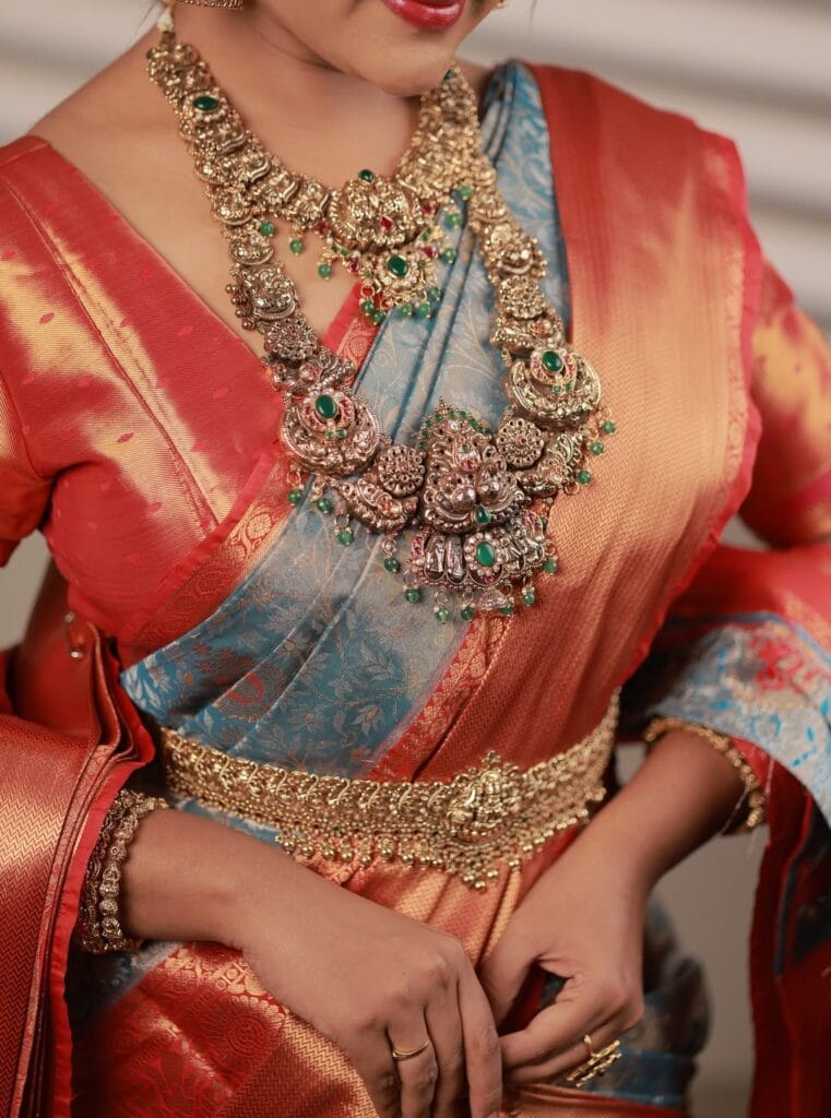 Bride trying on imitation bridal jewellery set before renting in Erode